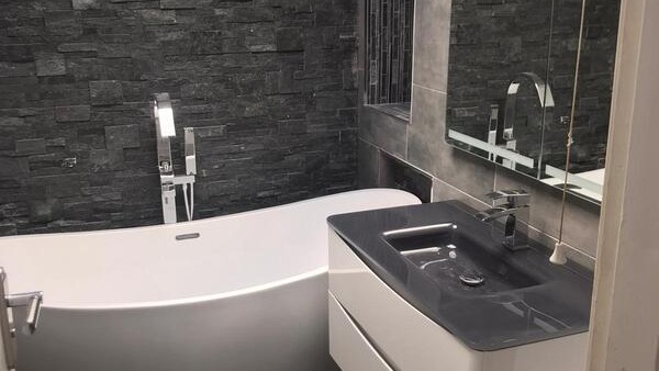 woman-in-freestanding-bathtub-brass-tap-candles